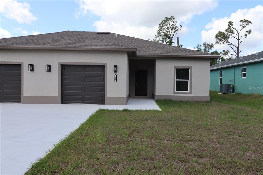 305 Lomond Drive Port Charlotte, FL 33953 - Photo 1 of 12 a front view of a house with a yard