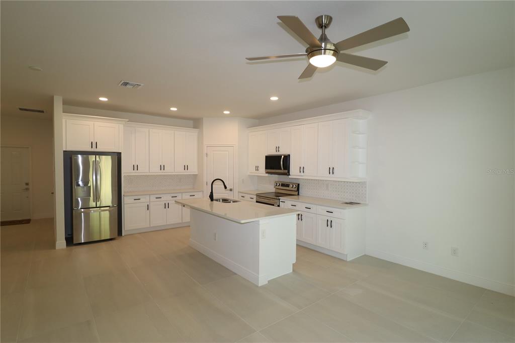 305 Lomond Drive Port Charlotte, FL 33953 - Photo 3 of 12 a view of kitchen with stainless steel appliances kitchen island sink refrigerator stove and white cabinets