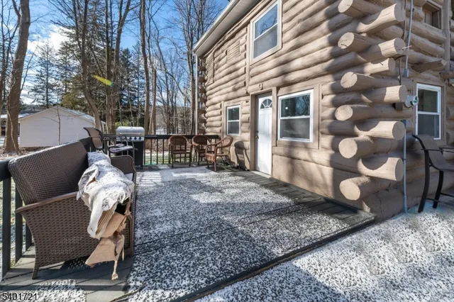 a view of a house with a yard covered in snow