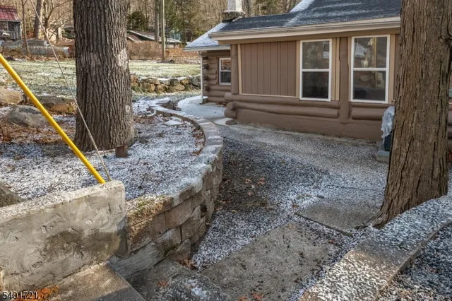 a view of a chair and table in the backyard