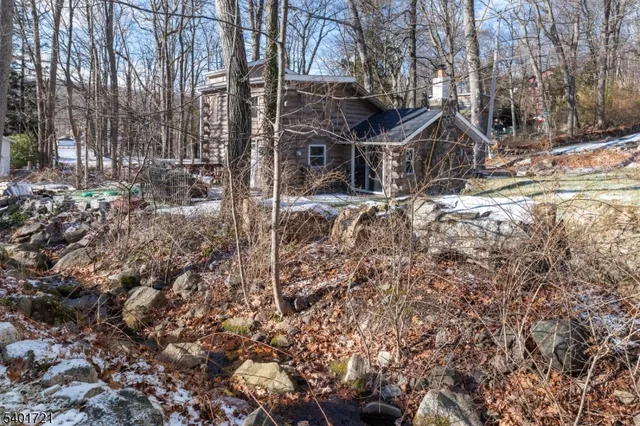 a view of a house with a yard covered in snow