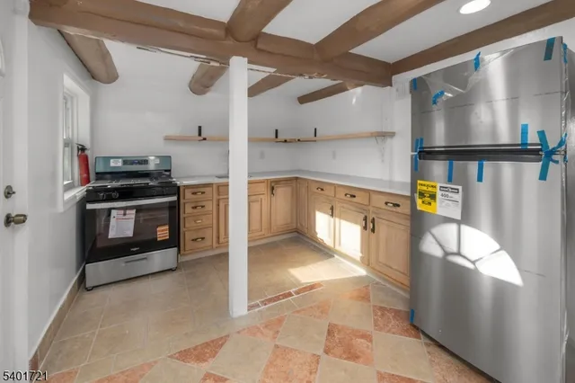a kitchen with stainless steel appliances granite countertop a stove and a refrigerator