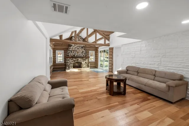 a bedroom with furniture and a large window
