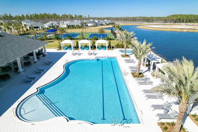 a view of a swimming pool with outdoor seating