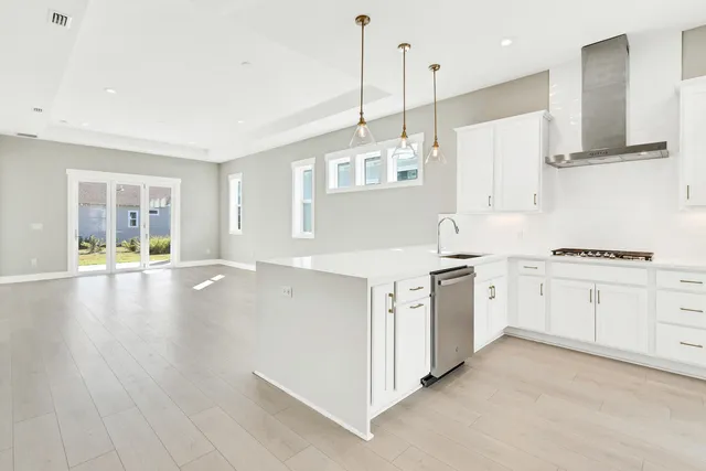 a kitchen with cabinets appliances and a wooden floor