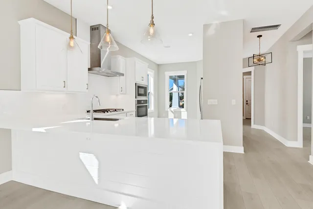 a view of kitchen with refrigerator and window