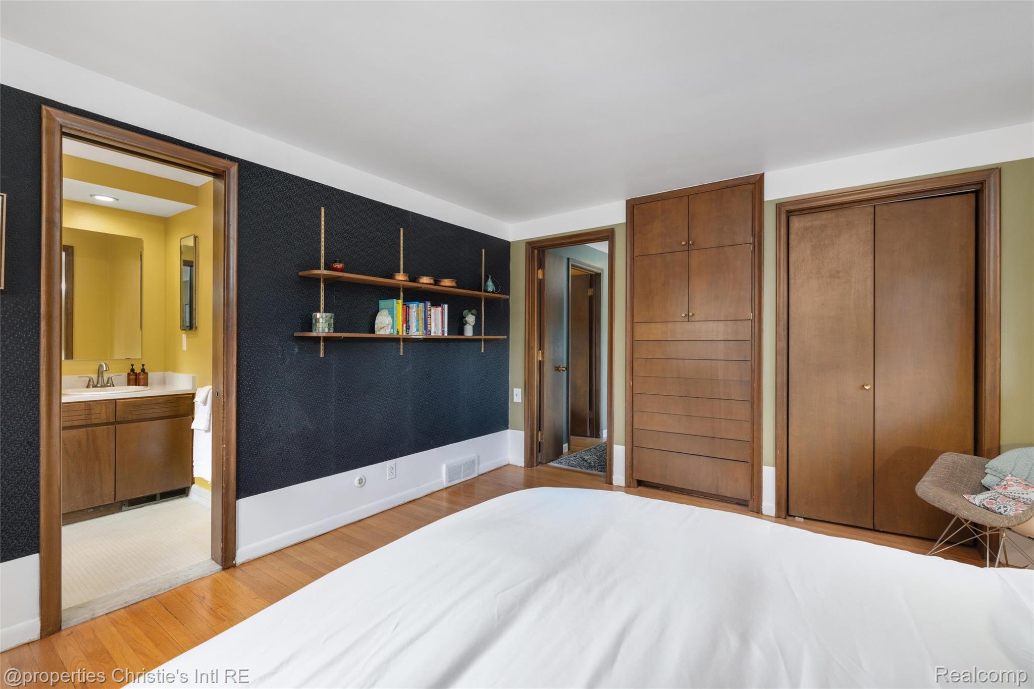 2771 West Seven Mile Road Detroit, MI 48221 - Photo 45 of 57 Bedroom featuring wood-finish flooring, built-in shelving, and two built-in closet storage units