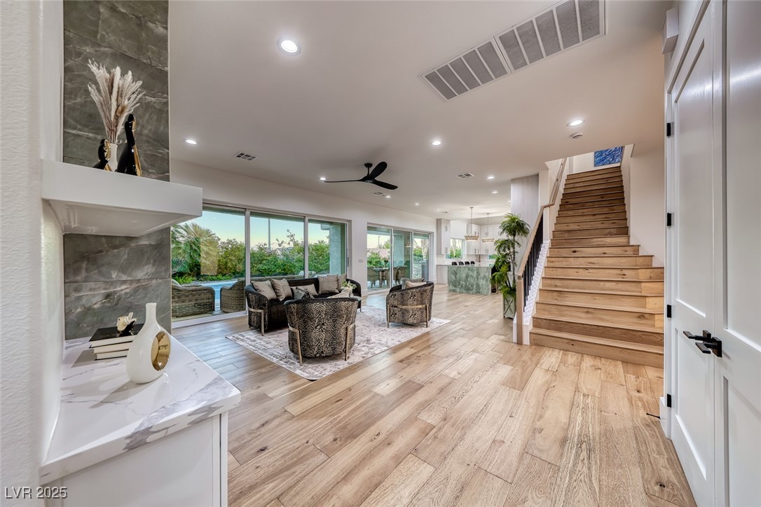 2309 Prometheus Court Henderson, NV 89074 - Photo 12 of 70 Living area with stairs, light wood-style floors, recessed lighting, and a ceiling fan