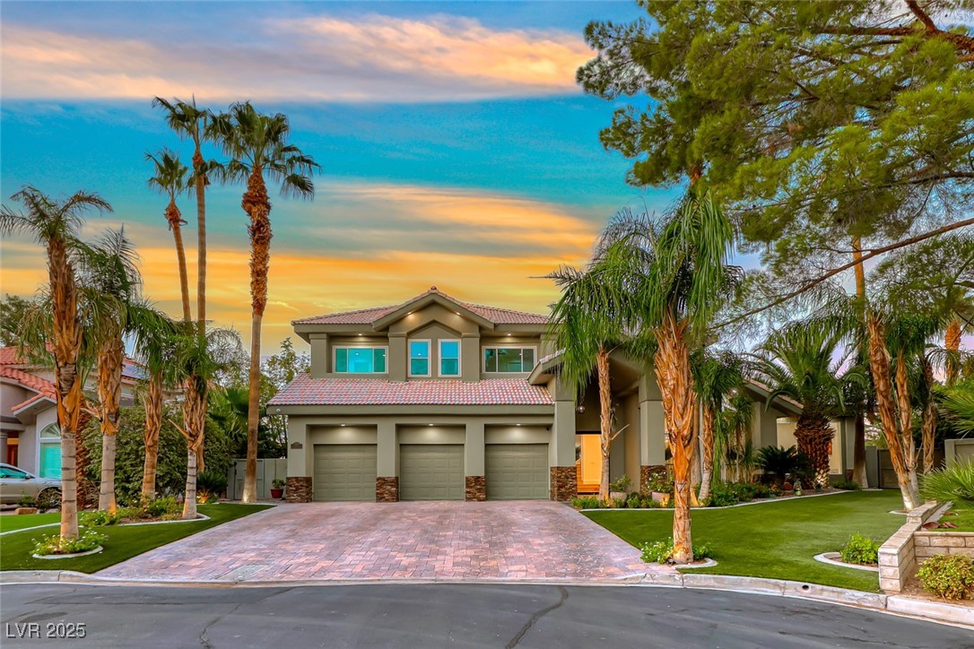 2309 Prometheus Court Henderson, NV 89074 - Photo 4 of 70 View of front facade with a lawn, stucco siding, stone siding, and decorative driveway