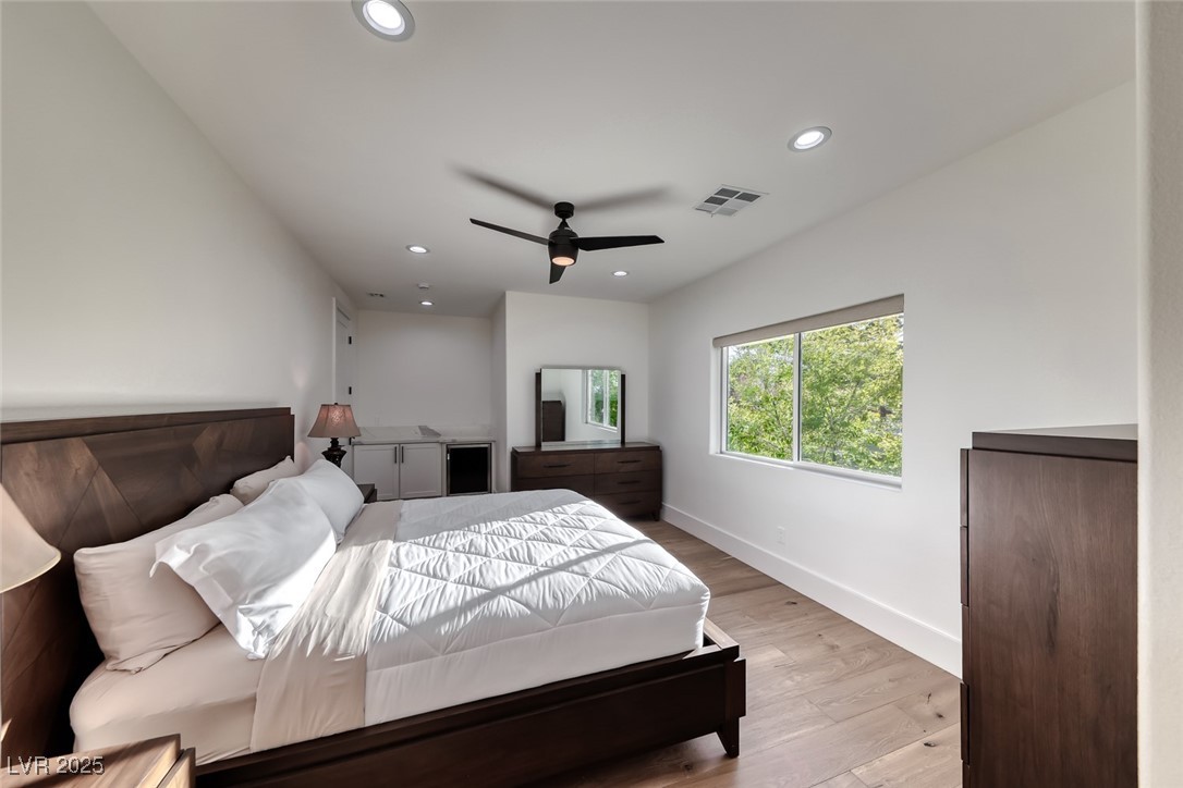 2309 Prometheus Court Henderson, NV 89074 - Photo 43 of 70 Bedroom with light wood finished floors, recessed lighting, wine cooler, and a ceiling fan