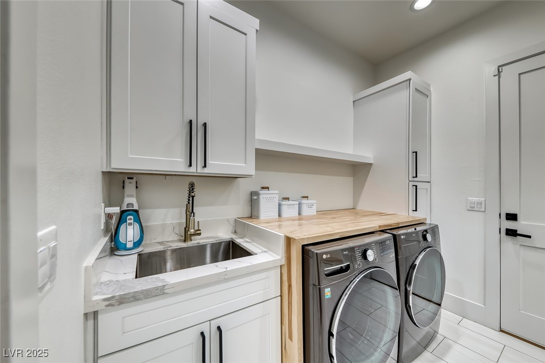2309 Prometheus Court Henderson, NV 89074 - Photo 50 of 70 Laundry room with independent washer and dryer, cabinet space, recessed lighting, and light tile patterned flooring