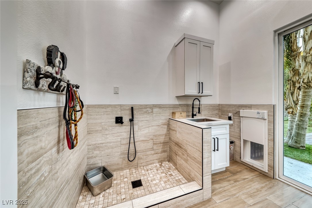 2309 Prometheus Court Henderson, NV 89074 - Photo 52 of 70 Bathroom featuring vanity, tile walls, and a wainscoted wall