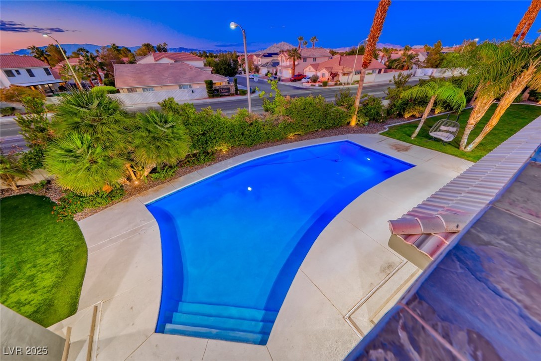 2309 Prometheus Court Henderson, NV 89074 - Photo 66 of 70 Pool at dusk featuring an outdoor pool, a residential view, and a patio