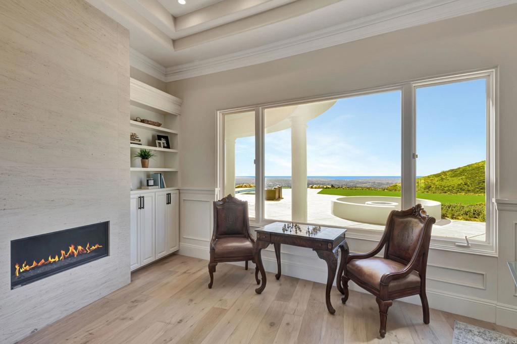 8025 La Milla Rancho Santa Fe, CA 92067 - Photo 12 of 51 a living room with furniture and a floor to ceiling window