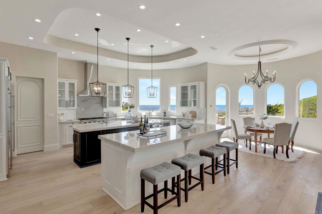 8025 La Milla Rancho Santa Fe, CA 92067 - Photo 14 of 51 a large kitchen with a table and chairs