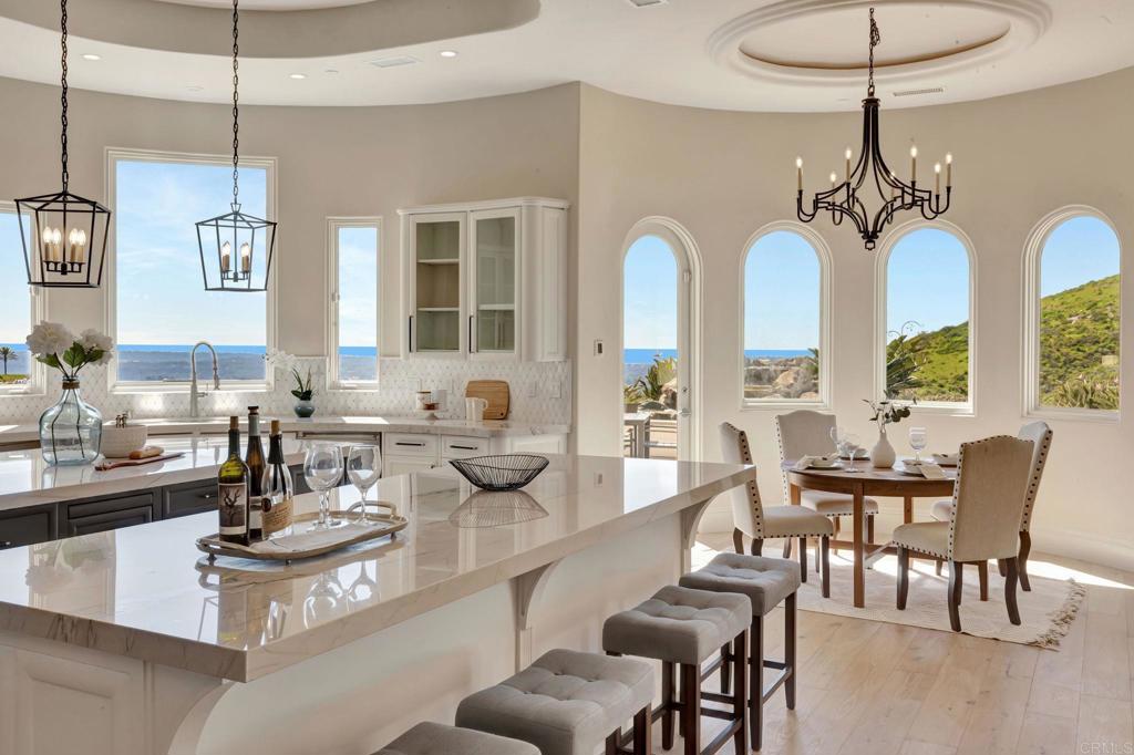 8025 La Milla Rancho Santa Fe, CA 92067 - Photo 16 of 51 a view of a dining room with furniture wooden floor and chandelier