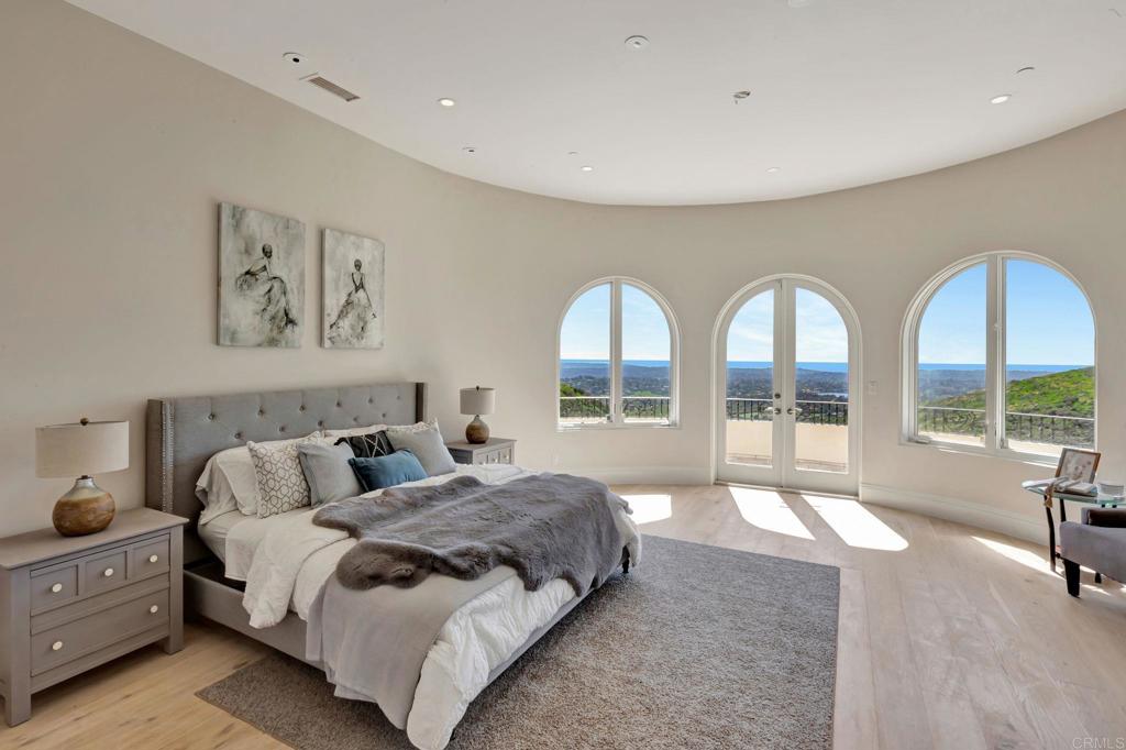 8025 La Milla Rancho Santa Fe, CA 92067 - Photo 22 of 51 a spacious bedroom with a bed and a large window