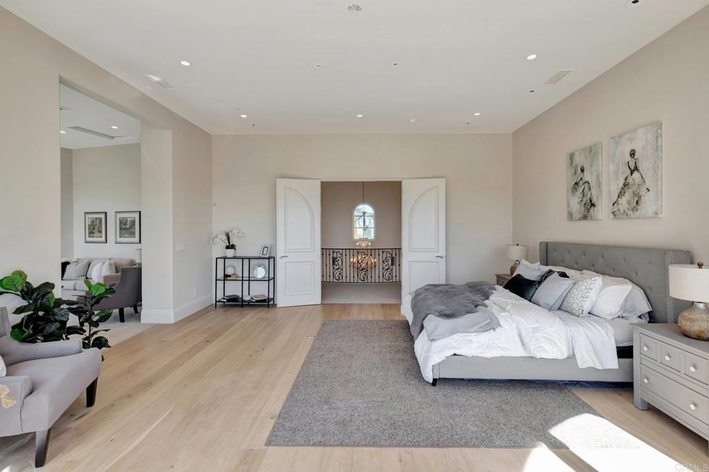 8025 La Milla Rancho Santa Fe, CA 92067 - Photo 23 of 51 a spacious bedroom with a bed and a couch