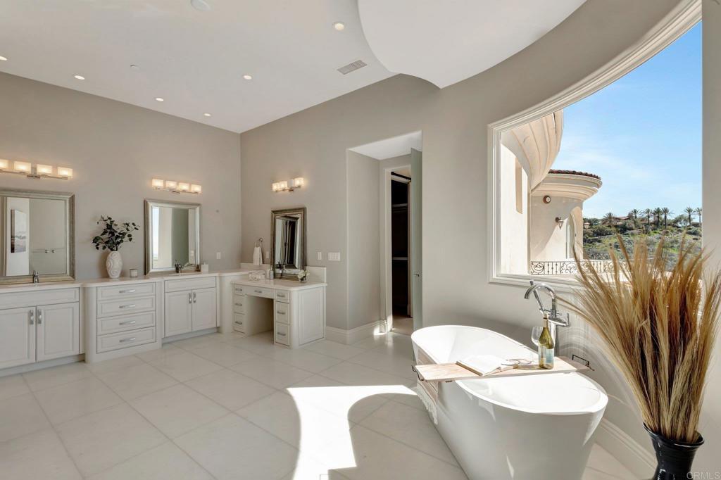 8025 La Milla Rancho Santa Fe, CA 92067 - Photo 27 of 51 a bathroom with a double vanity sink a mirror a toilet and bathtub