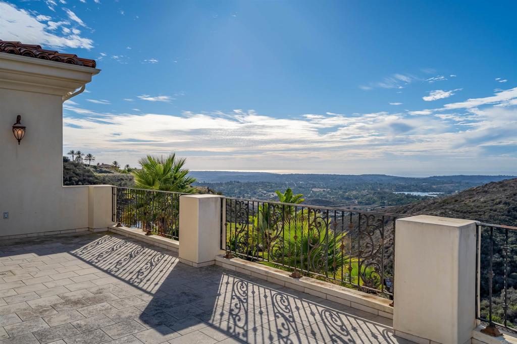 8025 La Milla Rancho Santa Fe, CA 92067 - Photo 29 of 51 a view of a balcony with two chairs and a table