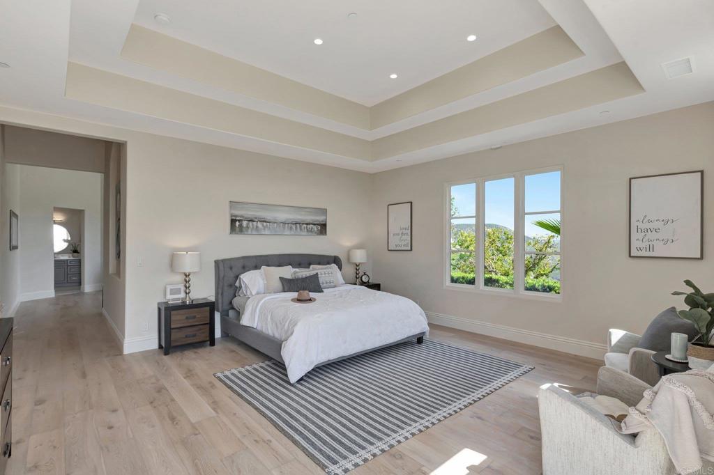 8025 La Milla Rancho Santa Fe, CA 92067 - Photo 31 of 51 a spacious bedroom with a bed and a couch