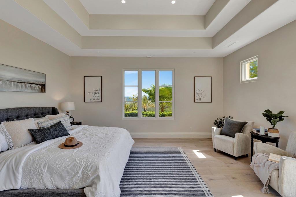 8025 La Milla Rancho Santa Fe, CA 92067 - Photo 33 of 51 a bedroom with bed and a couch