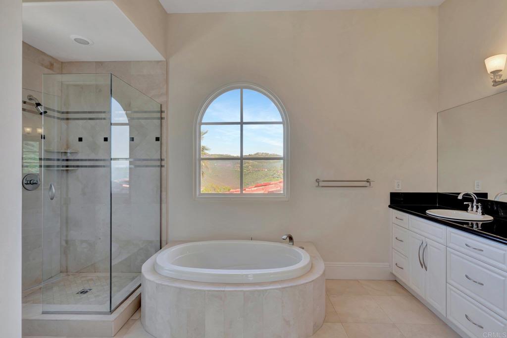 8025 La Milla Rancho Santa Fe, CA 92067 - Photo 39 of 51 a bathroom with a bathtub a toilet and a shower