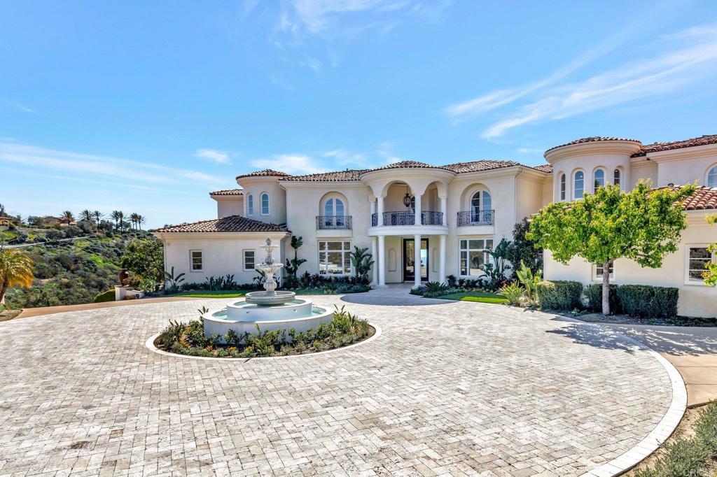 8025 La Milla Rancho Santa Fe, CA 92067 - Photo 4 of 51 a front view of a house with a yard
