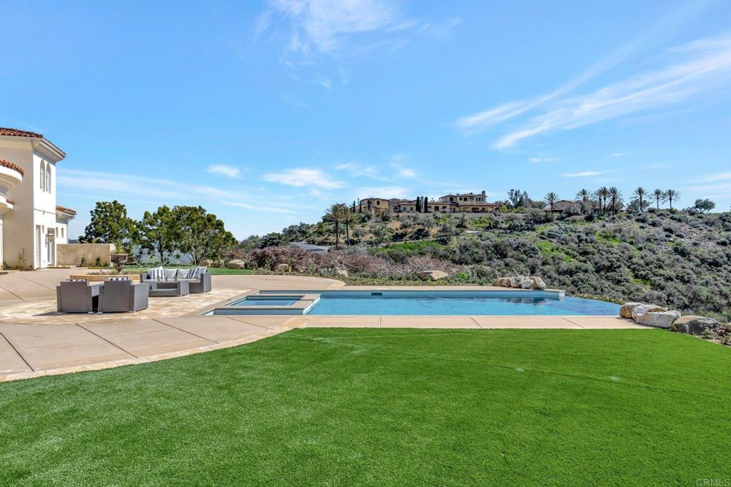 8025 La Milla Rancho Santa Fe, CA 92067 - Photo 45 of 51 a view of a swimming pool and a yard