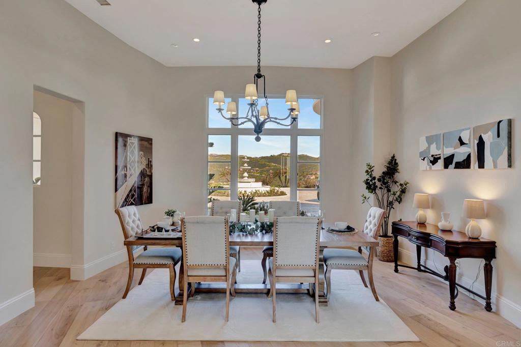 8025 La Milla Rancho Santa Fe, CA 92067 - Photo 9 of 51 a view of a dining room with furniture window and wooden floor