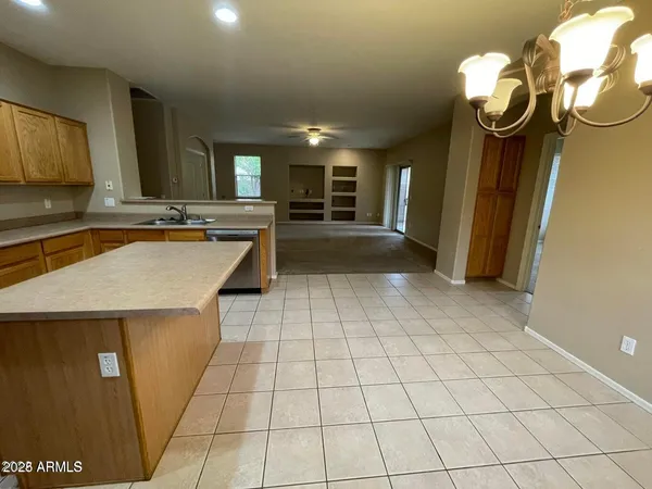 a view of a kitchen with a sink and cabinets