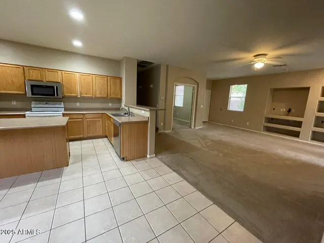 a kitchen with stainless steel appliances a stove a sink and a refrigerator