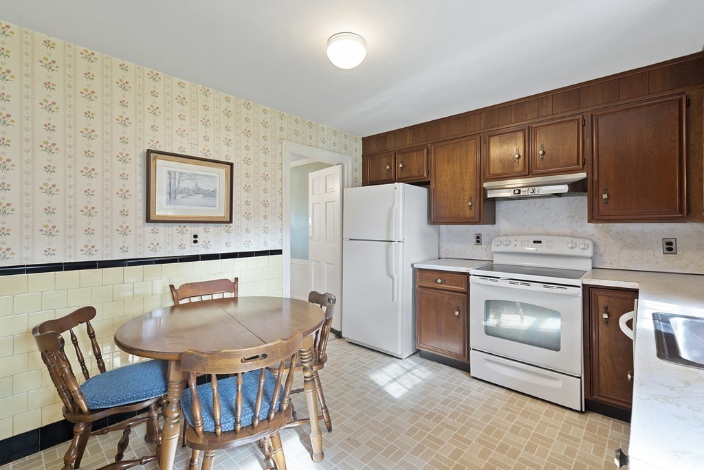 41 Sevinor Road Marblehead, MA 01945 - Photo 11 of 30 a kitchen with stainless steel appliances a stove a refrigerator a table and chairs