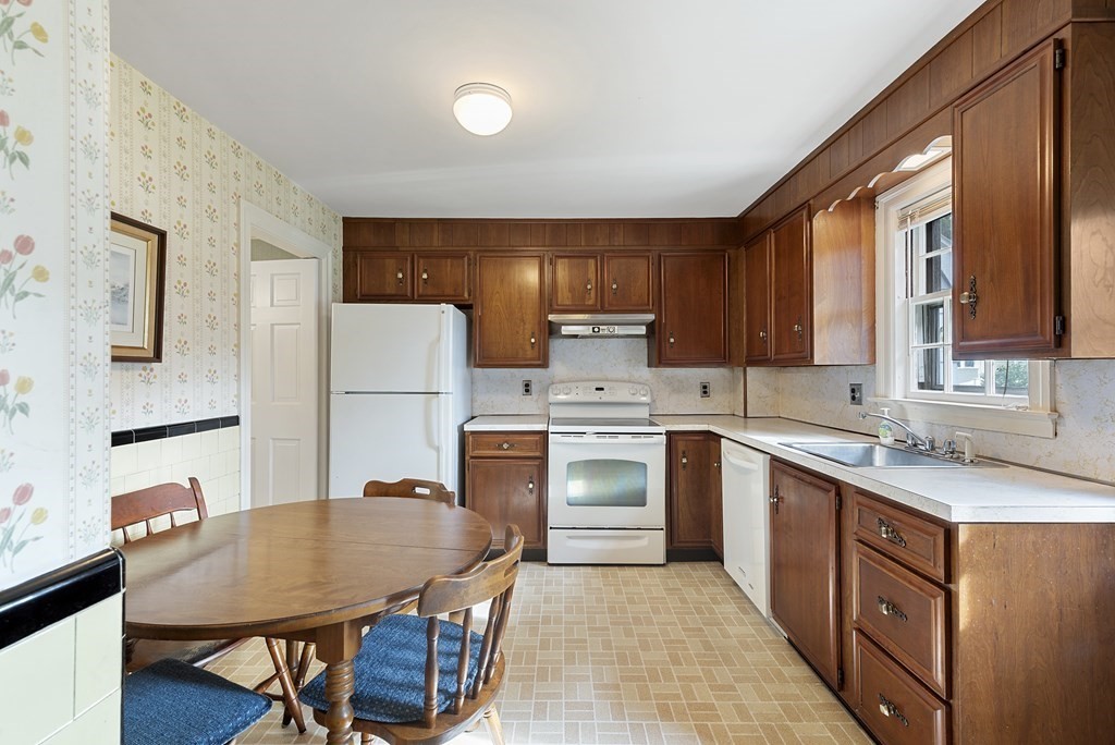 41 Sevinor Road Marblehead, MA 01945 - Photo 10 of 30 a kitchen with stainless steel appliances granite countertop a stove a sink dishwasher a refrigerator white cabinets and wooden floor