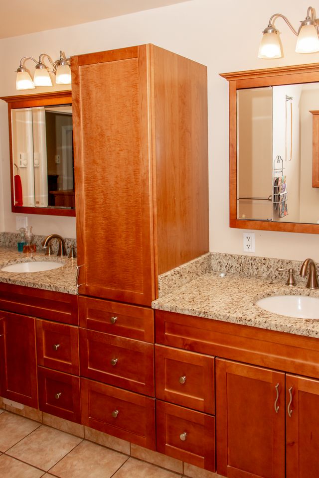 700 Newlins Road East Easton, PA 18040 - Photo 18 of 42 Dual vanities with granite counters and rich wood cabinetry define this well-appointed bathroom space.