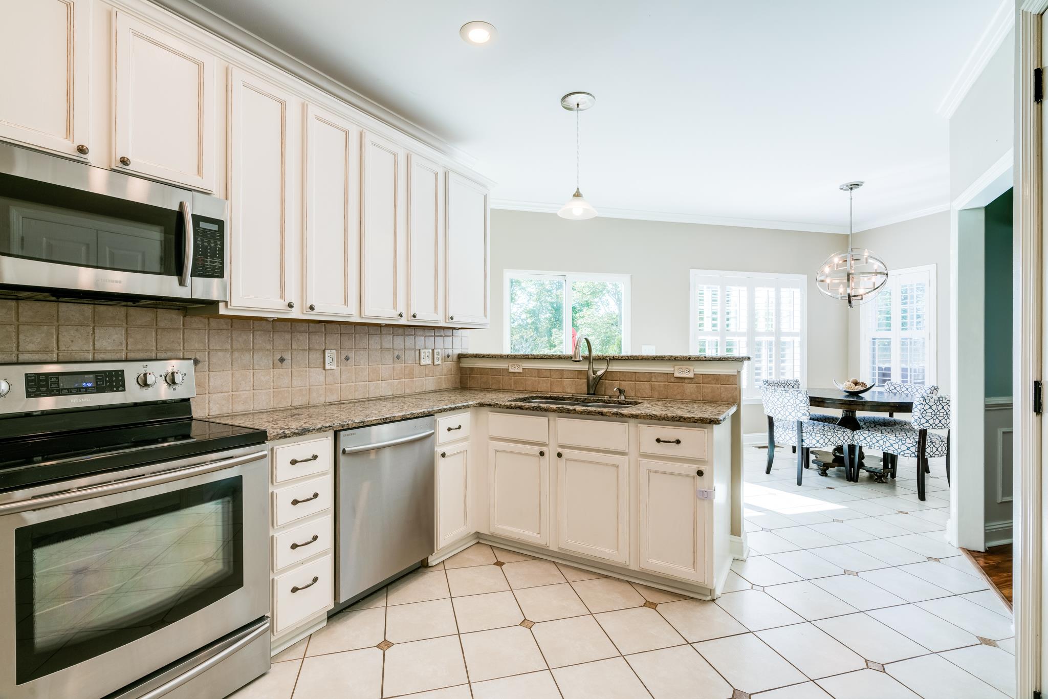 3126 Vera Valley Road Franklin, TN 37064 - Photo 11 of 30 a kitchen with stainless steel appliances granite countertop a stove a sink and a microwave