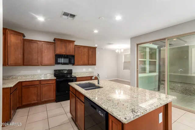 a kitchen with granite countertop a sink and a stove top oven