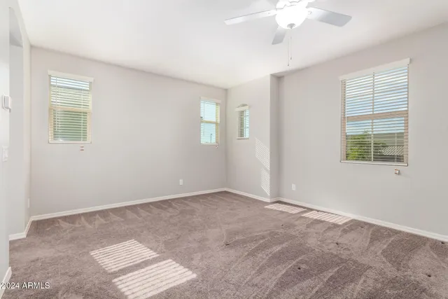 an empty room with windows and closet