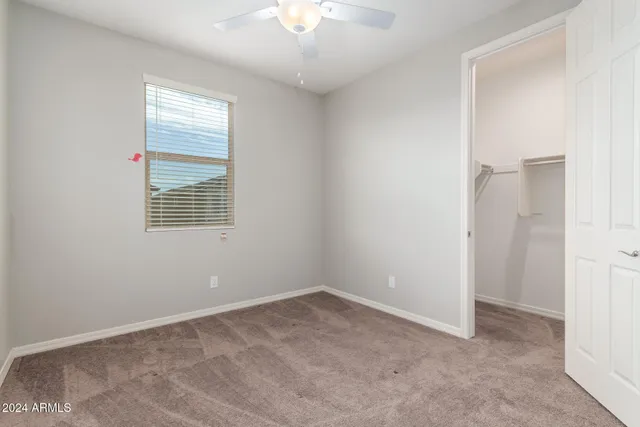 an empty room with closet and a bathroom