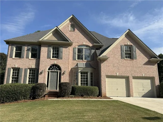 a front view of a house with a yard