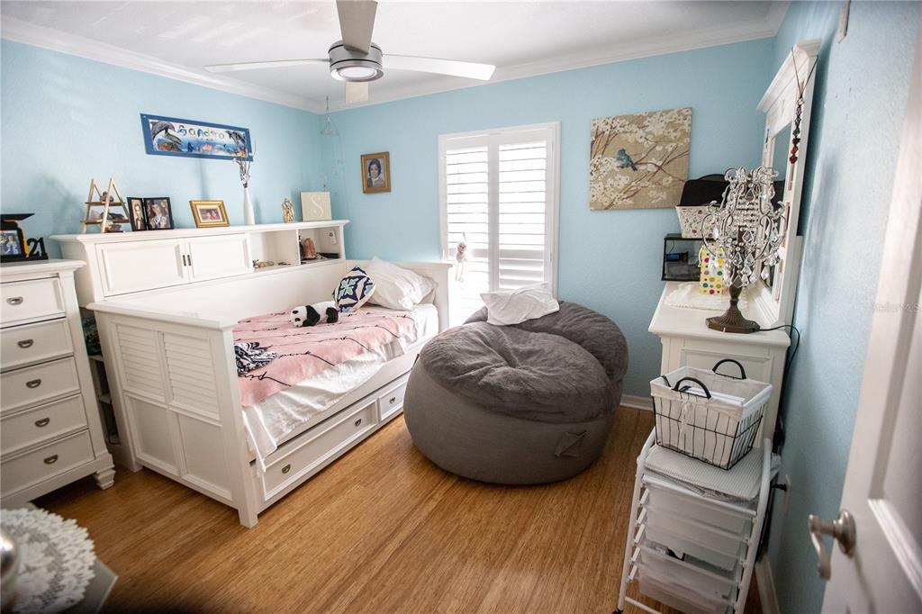 8911 Blind Pass Road, Unit 220 St. Pete Beach, FL 33706 - Photo 23 of 67 a bedroom with a bed and a window