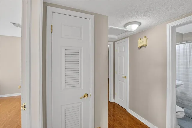 a view of empty room with wooden floor