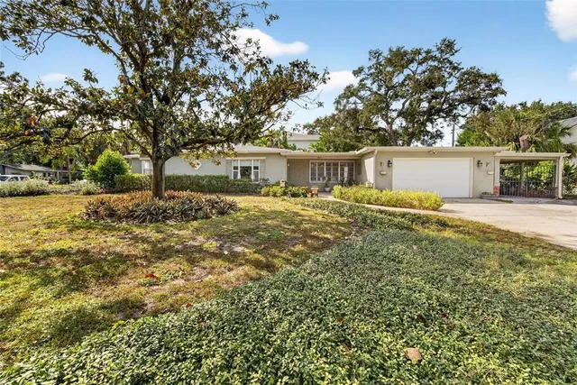a backyard of a house with table and chairs