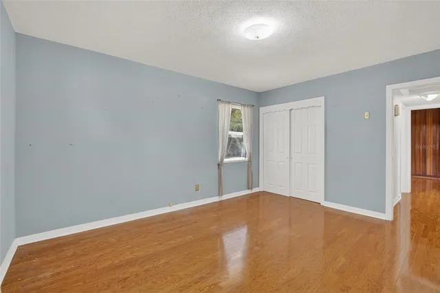 a bathroom with a granite countertop sink a mirror and shower