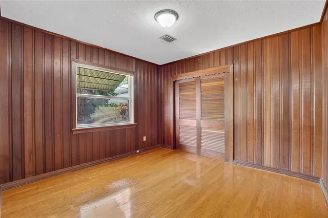a view of an empty room with wooden walls