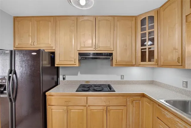 a kitchen with stainless steel appliances granite countertop white cabinets a sink and dishwasher