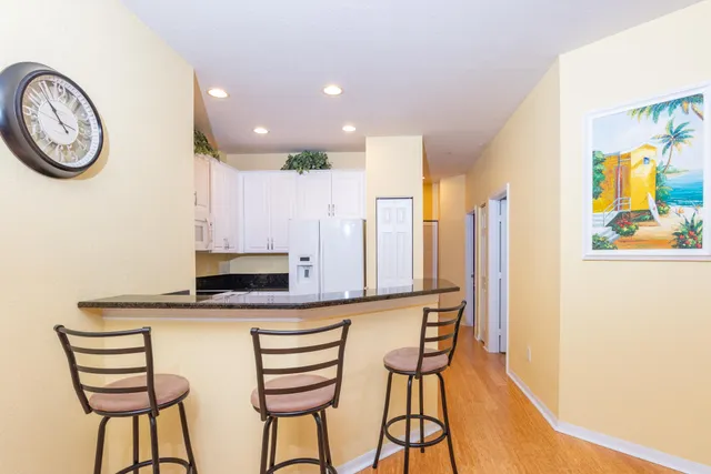 a kitchen with stainless steel appliances kitchen island granite countertop a stove and a microwave