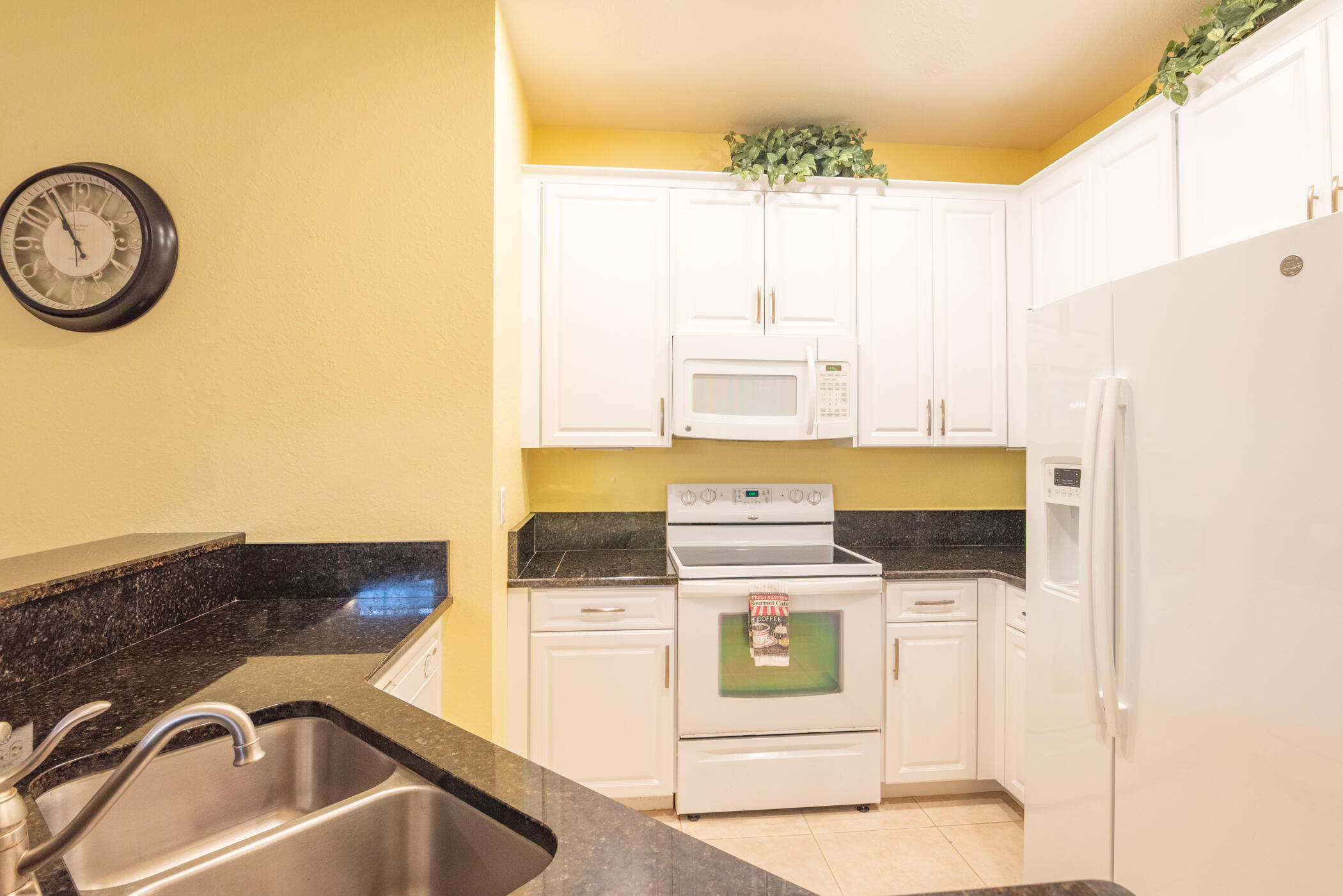 1600 Southeast Sheffield Terrace, Unit 201 Stuart, FL 34994 - Photo 14 of 28 a bathroom with a sink and a stove