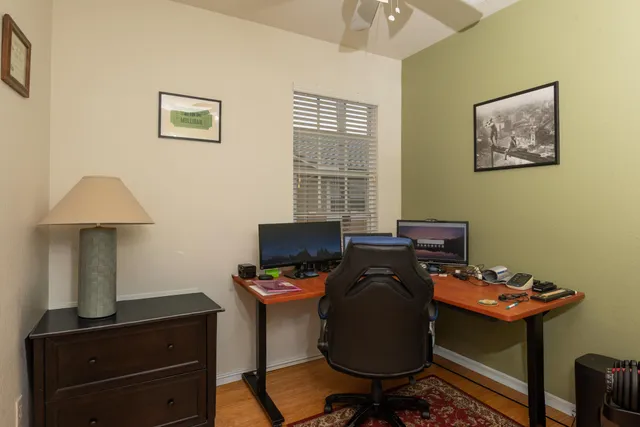 a view of a workspace with furniture and a window