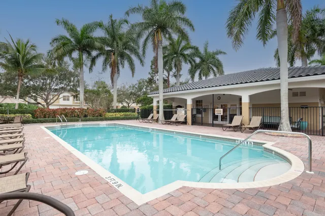 a view of a swimming pool with chair and tables